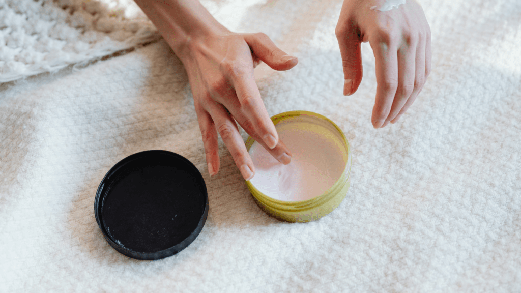 woman putting cream on her hand